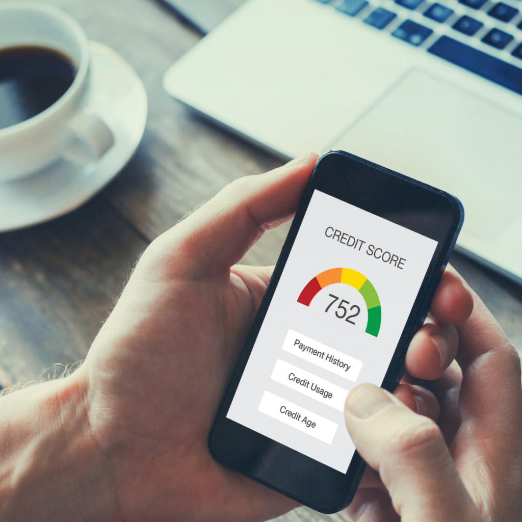 A person holding a phone looking at their credit score.