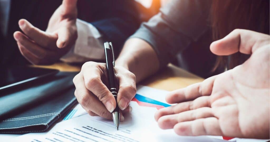 A person signing a document.