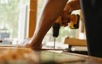 Man working to install new wood floors in a home