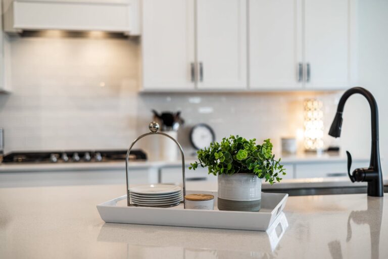 White kitchen with decorative tray on island.