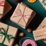 Christmas gifts wrapped in brown paper with ribbon tied around them.