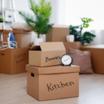 Living room with moving boxes with labels on them.