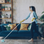 Young women cleaning her living room.